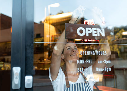 business owner hanging open sign