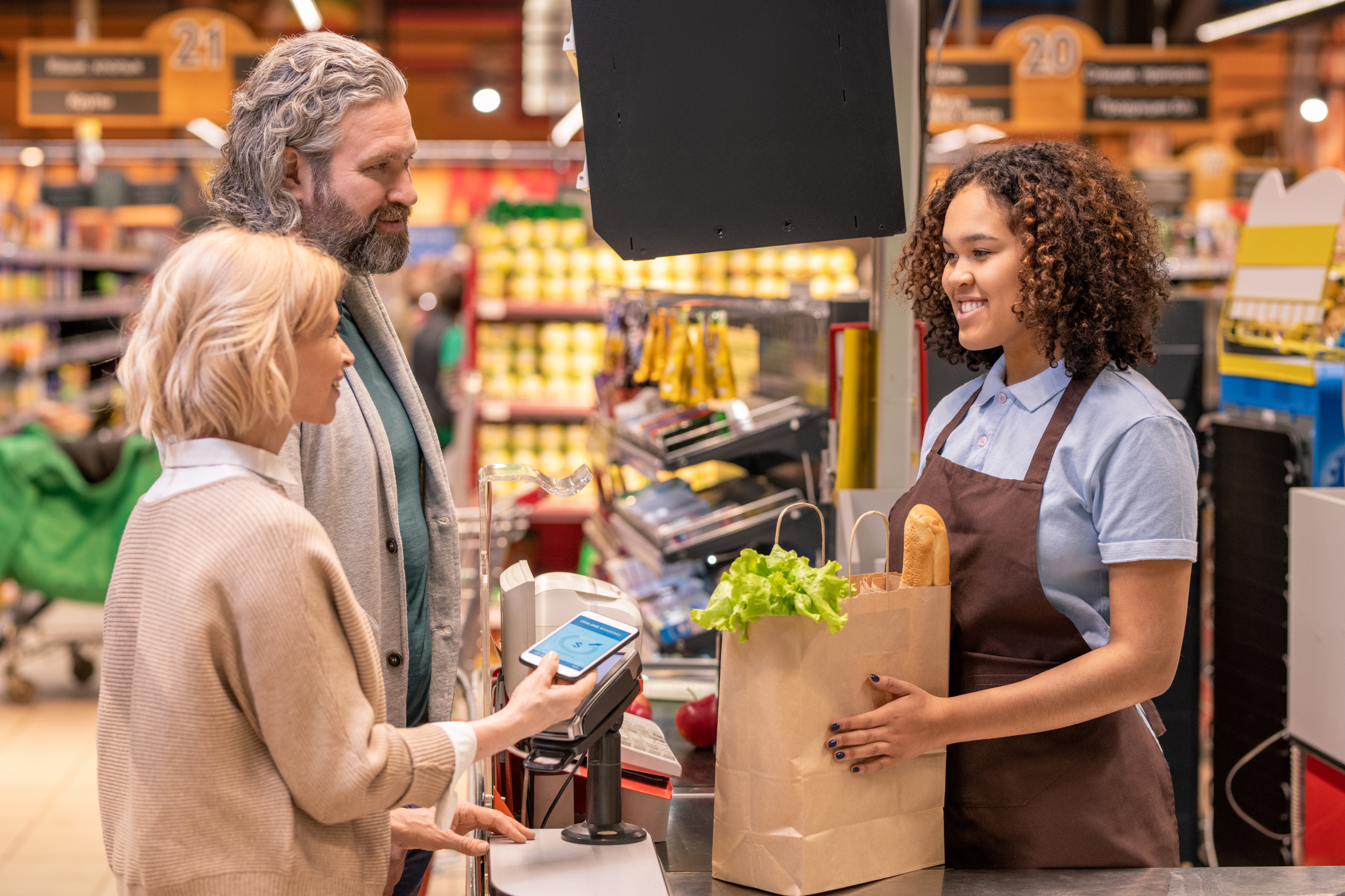 While market. Покупательское поведение. Пожилая женщина с корзиной в супермаркете.